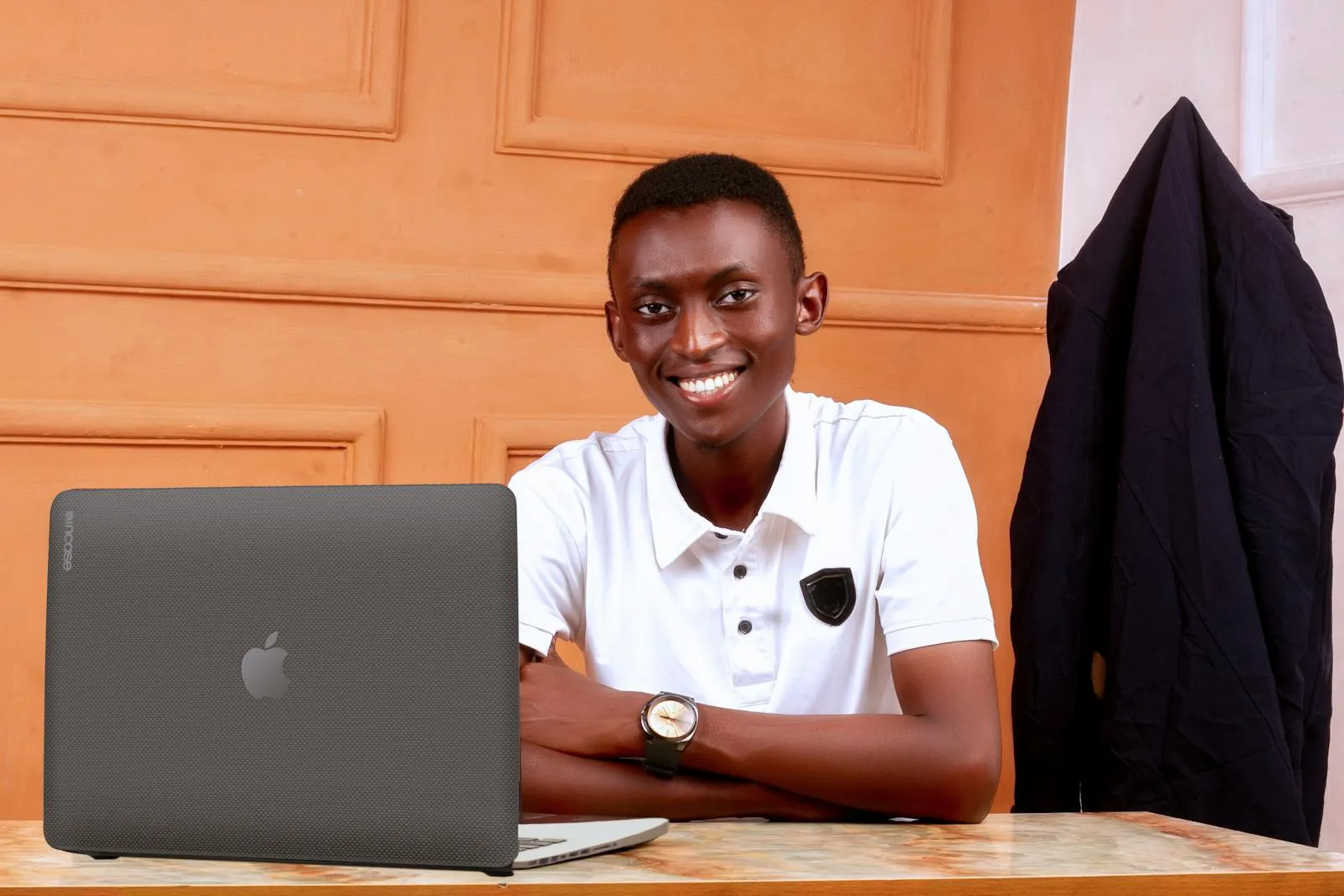 A happy Hatzlacha College student with a laptop